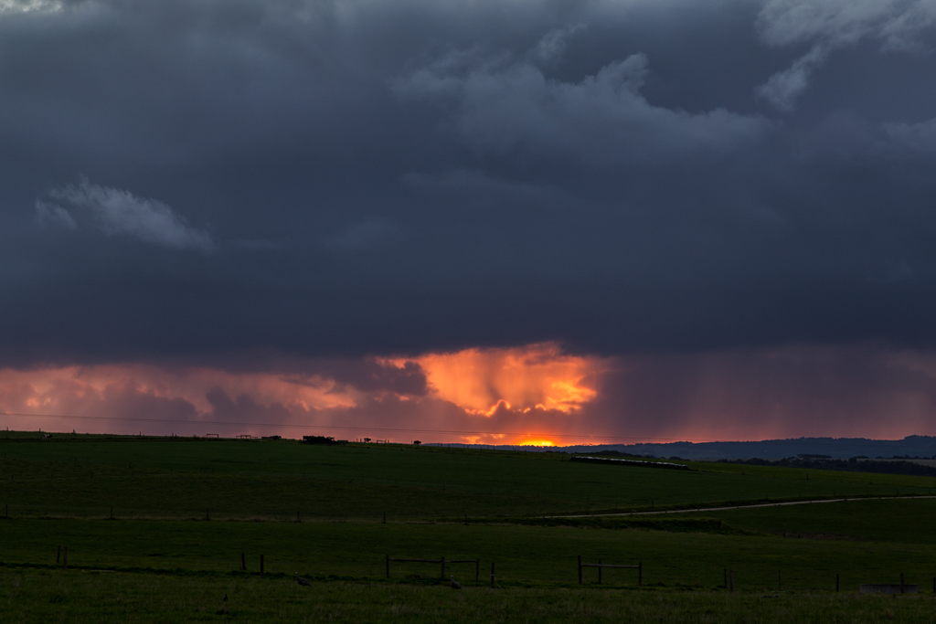 sunset-storm-clouds-over-green-fields