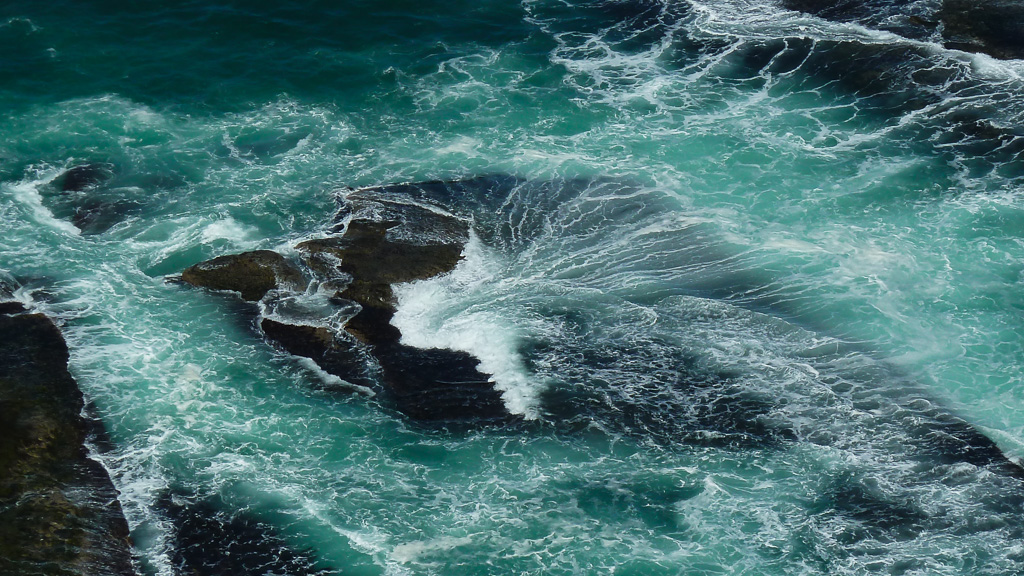 waves-breaking-over-rocks