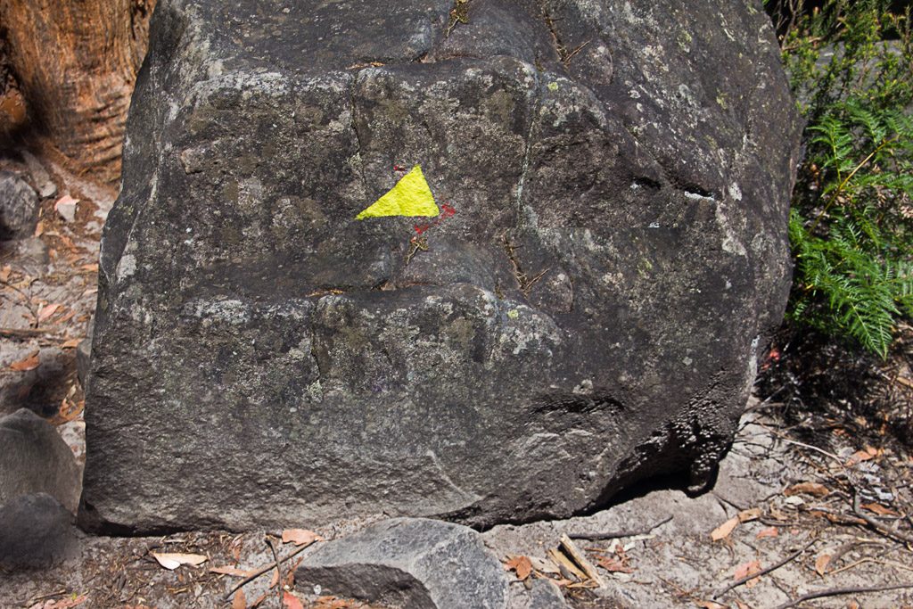 yellow-arrow-on-rock