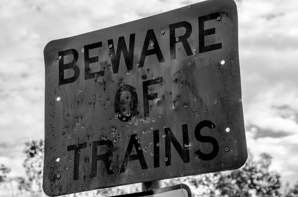 beware-of-trains-sign-bullet-holes