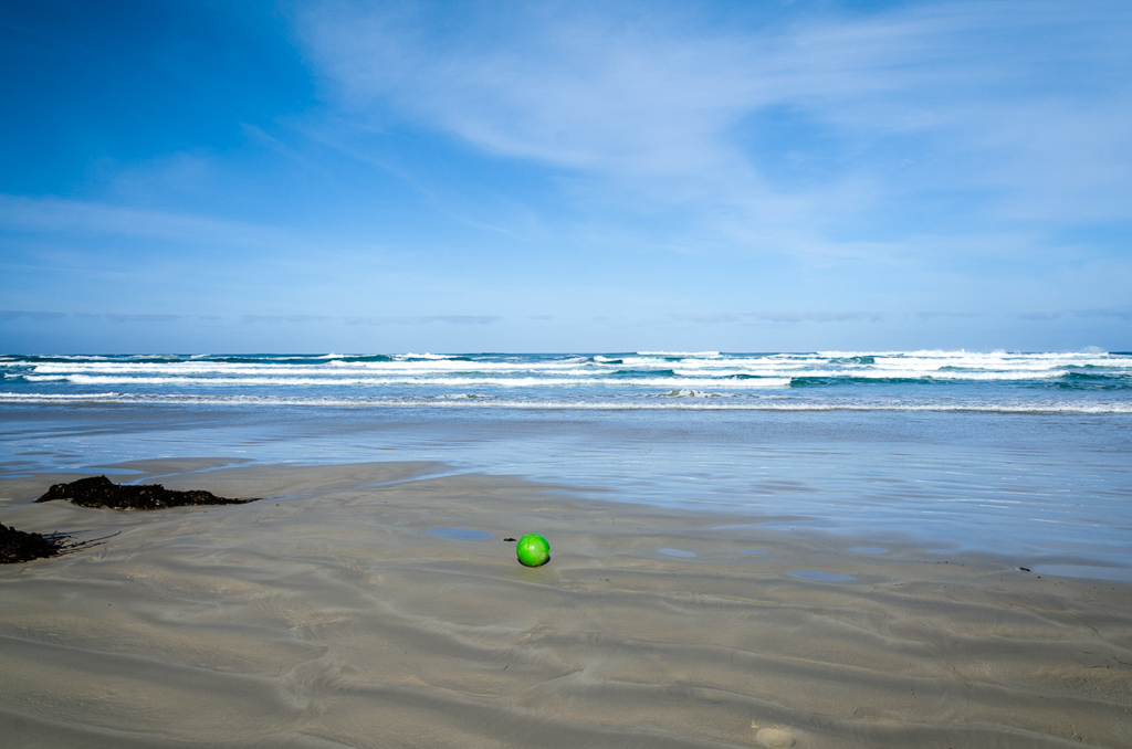 green-buoy-on-beach