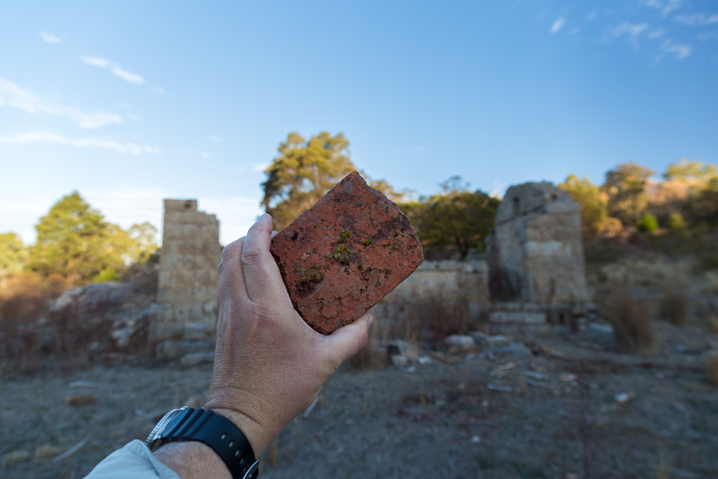 holding-red-brick-granite-cottage-ruins