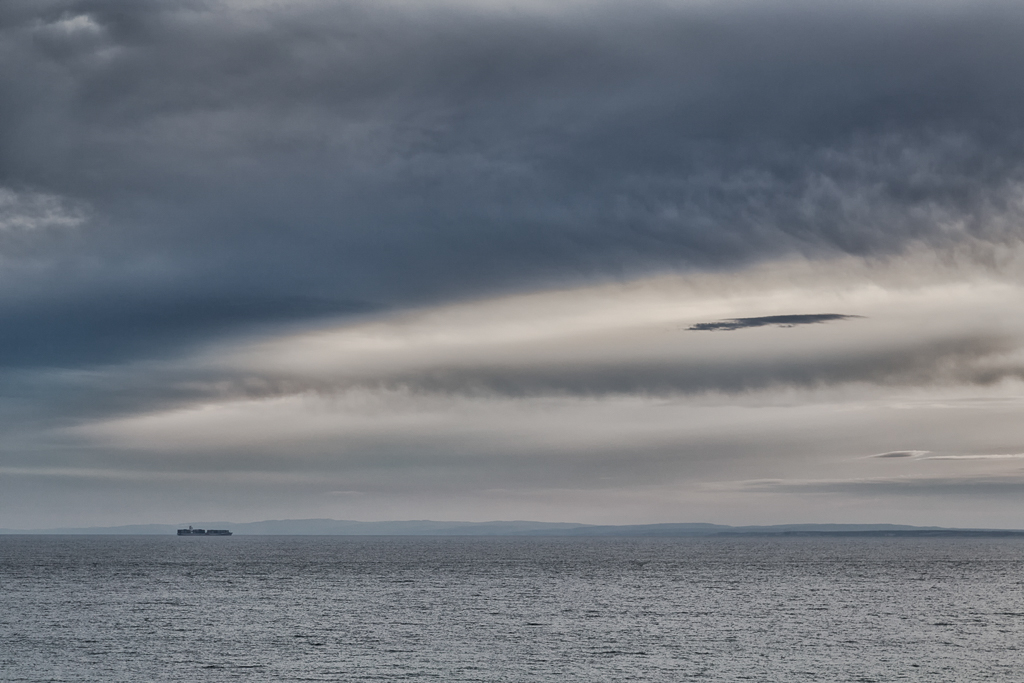 ship-at-sea-under-dark-clouds