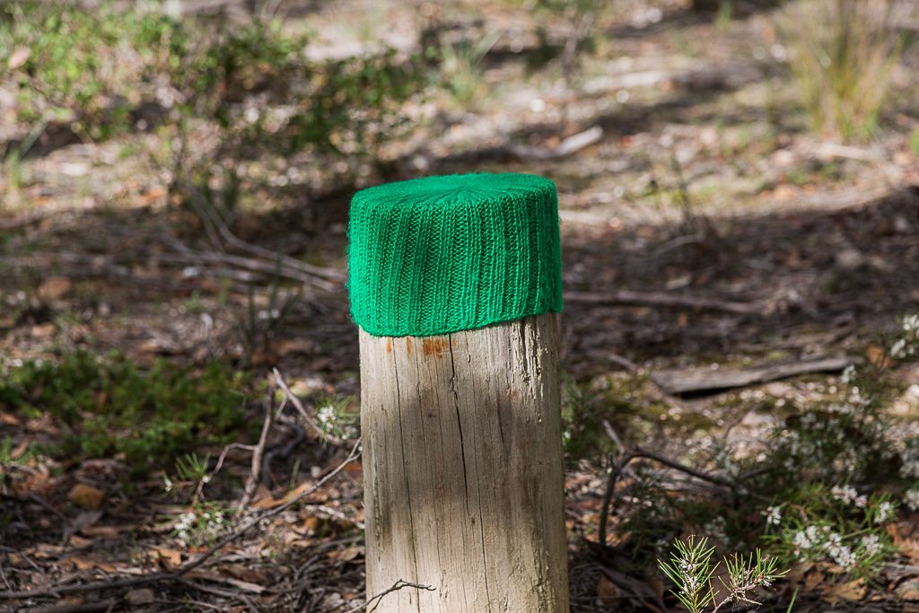woolen-hat-on-timber-pole
